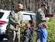 YORKTOWN, Va. (April 5, 2024) Ensign Darelle Moore, Naval Weapons Station (NWS) Yorktown’s Security Officer and Chief Ethan Holland, assigned to the installation’s Security Department, hand out stickers to military affiliated youths during a parade as part of the Month of the Military Child. (U.S. Navy Photo by Max Lonzanida/Released).