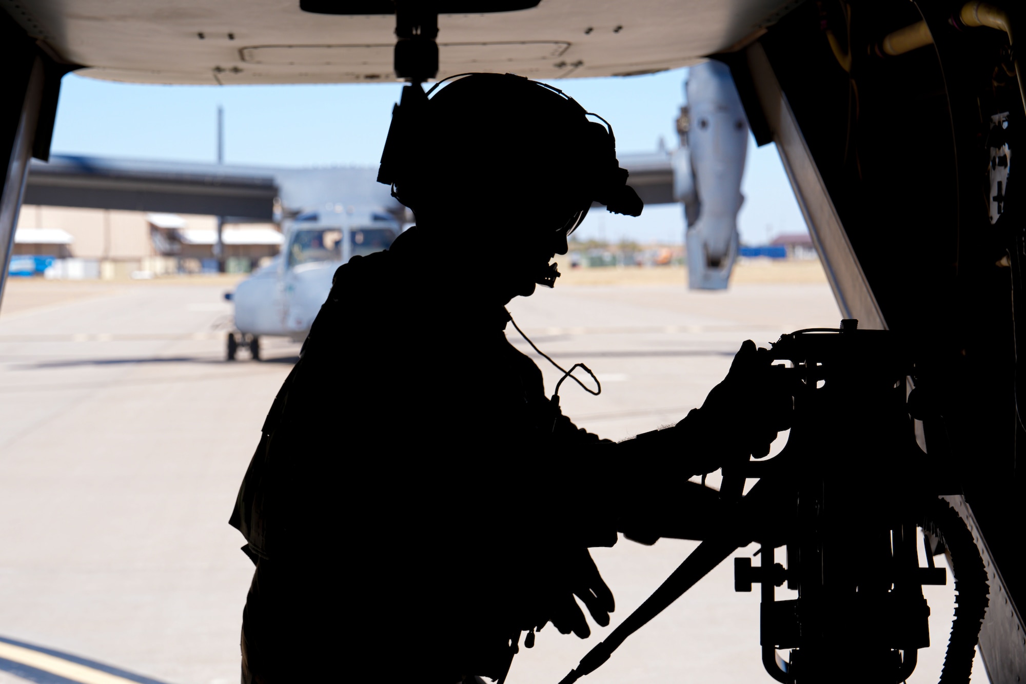 A U.S. Air Force Airman assigned to the 20th Special Operations Squadron prepares for take-off aboard a CV-22 Osprey at Cannon Air Force Base, New Mexico, Oct. 9, 2024. The CV-22 Osprey is a tiltrotor aircraft that combines the vertical takeoff, hover and vertical landing qualities of a helicopter with the long-range, fuel efficiency and speed characteristics of a turboprop aircraft. (U.S. Air Force photo by Airman 1st Class Gracelyn Hess)