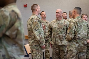 Chief Master Sgt. of the Air Force David Flosi speaks with command chiefs during Senior Enlisted Leader Mission Command Training on Joint Base Pearl Harbor-Hickam, Hawaii, Oct. 21, 2024. The six-day training will place SELs in resource-limited locations and scenarios to experience the capabilities and limitations of agile combat employment deployments. (U.S. Air Force photo by Airman 1st Class Aden Brown)