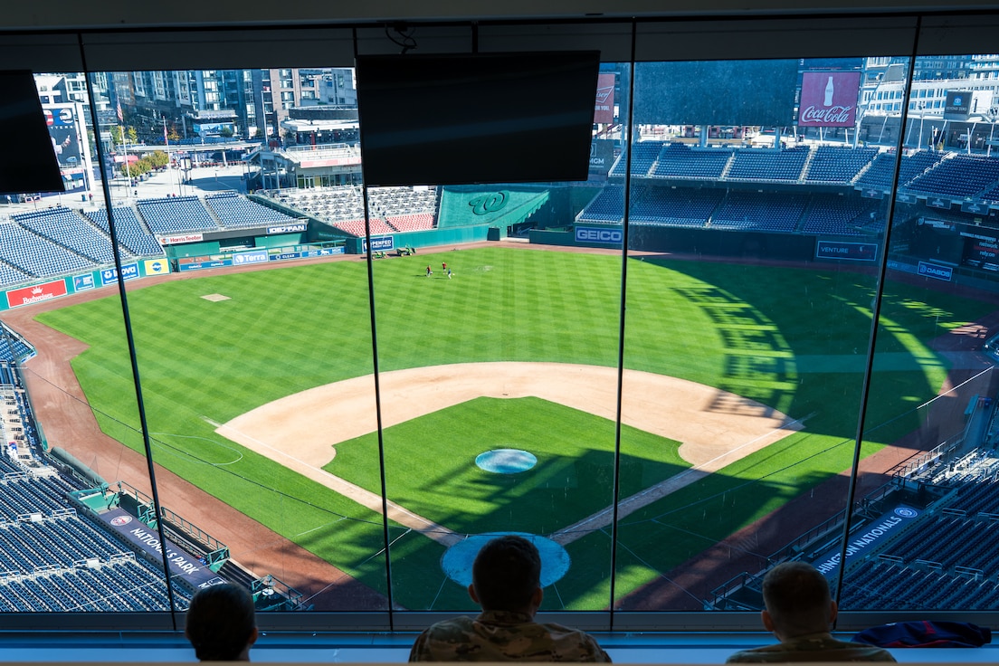 Three U.S. Air Force Airmen overlook Nationals Park.