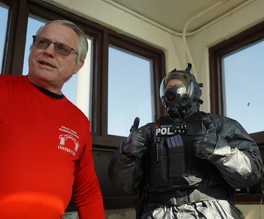 YORKTOWN, Va. (February 14, 2024) Sean McDonald, a Law Enforcement Instructor assigned to Naval Weapons Station Yorktown, assists a member of the installation’s Security Department don personal protective equipment at the installation’s weapons pier. This particular drill was part of the larger Exercise Citadel Shield-Solid Curtain 2024 (CS-SC24). CS-SC24 is an annual, two-part force protection exercise conducted by U.S. Fleet Forces Command and Commander, Navy Installations Command on all CONUS Navy installations. (U.S. Navy Photo by Max Lonzanida/Released).