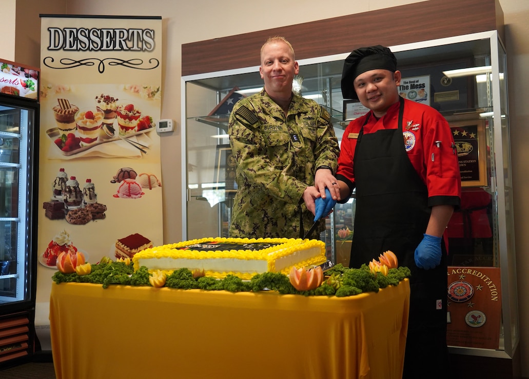 YORKTOWN, Va. (February 22, 2024) Chief Warrant Officer 3 David Burston, Food Service Officer and Culinary Specialist First Class Johnpaul Pedero cut a cake as part of the Black History Month special meal at Naval Weapons Station (NWS) Yorktown’s Scudder Hall Galley. Each February, the U.S. Navy commemorates Black History Month and the significant role that African Americans, both past and present, have played in the defense of our Nation. Their contributions and sacrifice to our Nation are not just a part of African American history, but American history. (U.S. Navy Photo by Max Lonzanida/Released)