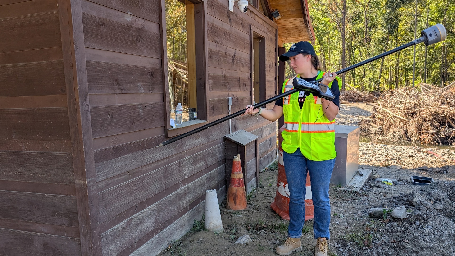 Cara Brown measures a high-water mark Oct. 10, 2024, in Hartford, Tennessee.  By collecting accurate measurements of Hurricane Helene flood levels and their impact, the Corps of Engineers is building a foundation for more effective planning and response to future weather events. (USACE Photo by Michael Krneta)