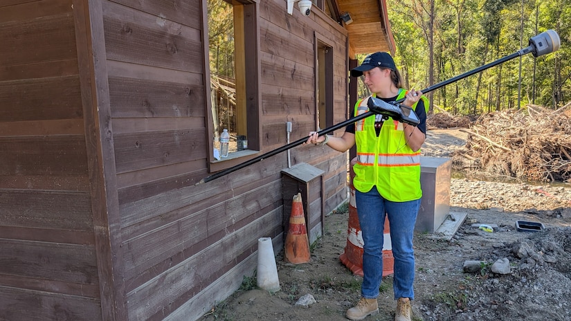 Cara Brown measures a high-water mark Oct. 10, 2024, in Hartford, Tennessee.  By collecting accurate measurements of Hurricane Helene flood levels and their impact, the Corps of Engineers is building a foundation for more effective planning and response to future weather events. (USACE Photo by Michael Krneta)