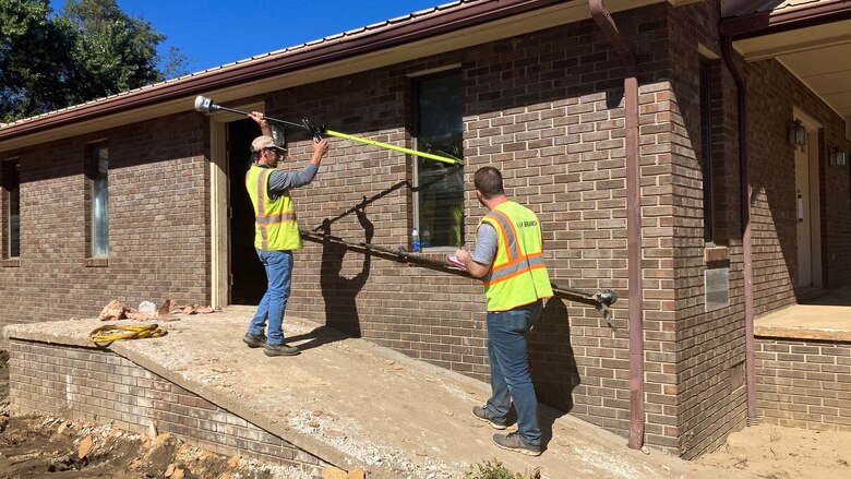Trevor Groce (Left) and Anthony Emiren measure a high-water mark Oct. 11, 2024, on Del Rio Baptist Church in Del Rio, Tennessee, which is in Cocke County. By collecting accurate measurements of Hurricane Helene flood levels and their impact, the Corps of Engineers is building a foundation for more effective planning and response to future weather events. (USACE Photo by Rebecca Midkiff)