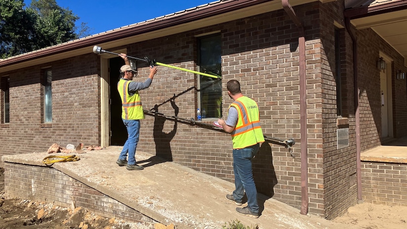 Trevor Groce (Left) and Anthony Emiren measure a high-water mark Oct. 11, 2024, on Del Rio Baptist Church in Del Rio, Tennessee, which is in Cocke County. By collecting accurate measurements of Hurricane Helene flood levels and their impact, the Corps of Engineers is building a foundation for more effective planning and response to future weather events. (USACE Photo by Rebecca Midkiff)