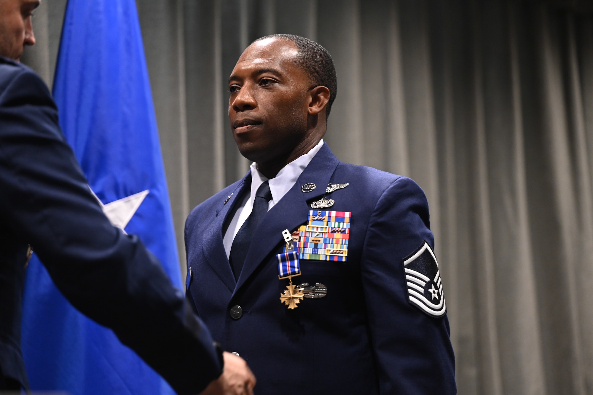 U.S. Air Force Master Sgt. Joshua Davis, 14th Weapons Squadron operations superintendent, has the Distinguished Flying Cross pinned on by Brig. Gen. Lawrence Sullivan, 57th Wing commander at Hurlburt Field, Florida, Oct. 8, 2024.