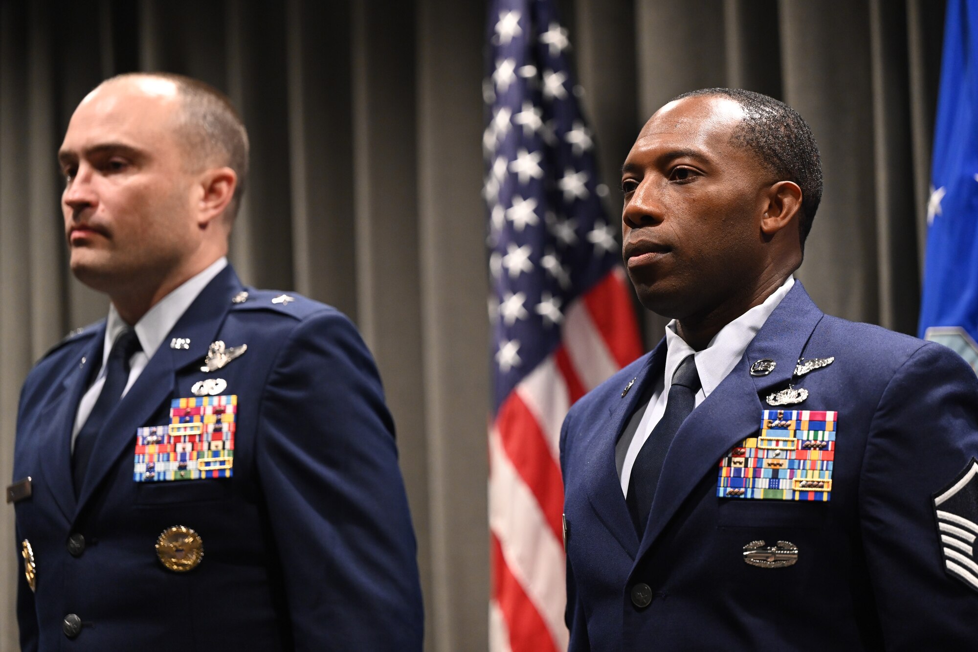 U.S. Air Force Master Sgt. Joshua Davis, 14th Weapons Squadron operations superintendent, stands with Brig. Gen. Lawrence Sullivan, 57th Wing commander,  at a Distinguished Flying Cross Ceremony held at Hurlburt Field, Florida, Oct. 8, 2024.