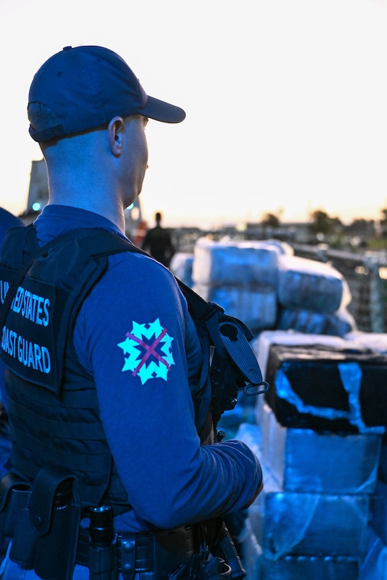 The crew of Coast Guard Cutter Resolute unload interdicted narcotics onto Sector St. Petersburg South Moorings, Florida, Oct. 23, 2024. Armed Coast Guardsmen stood watch over the interdicted drugs to ensure security and accountability of the seized contraband. (U.S. Coast Guard photo by Petty Officer 1st Class Riley Perkofski)