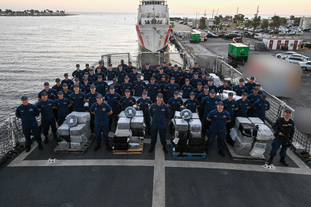 The crew of Coast Guard Cutter Resolute unload interdicted narcotics onto Sector St. Petersburg South Moorings, Florida, Oct. 23, 2024. Armed Coast Guardsmen stood watch over the interdicted drugs to ensure security and accountability of the seized contraband. (U.S. Coast Guard photo by Petty Officer 1st Class Riley Perkofski)