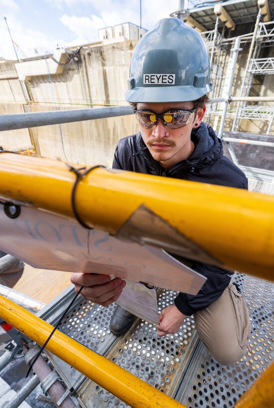 Xavierre Reyes, gas free tech, Navy competent person, Shop 11, Shipfitters Gas Free, prepares to perform a gas free drop test in a mud tank Oct. 10, 2024, at Puget Sound Naval Shipyard & Intermediate Maintenance Facility in Bremerton, Washington. (U.S Navy photo by Wendy Hallmark)