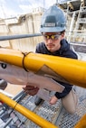Xavierre Reyes, gas free tech, Navy competent person, Shop 11, Shipfitters Gas Free, prepares to perform a gas free drop test in a mud tank Oct. 10, 2024, at Puget Sound Naval Shipyard & Intermediate Maintenance Facility in Bremerton, Washington. (U.S Navy photo by Wendy Hallmark)