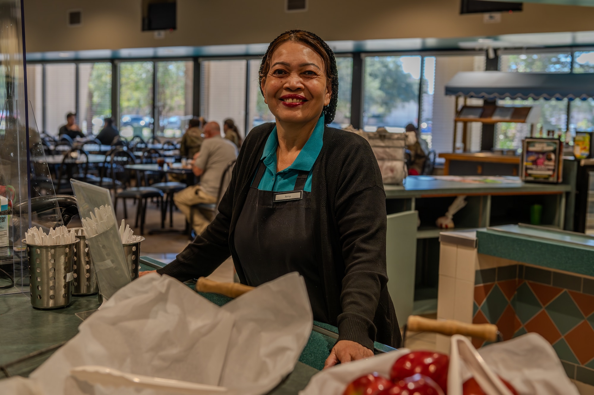 Amy Mason, food service specialist contractor, poses for a photo inside the Riptide Dining Facility at Hurlburt Field, Florida, Oct. 17, 2024.