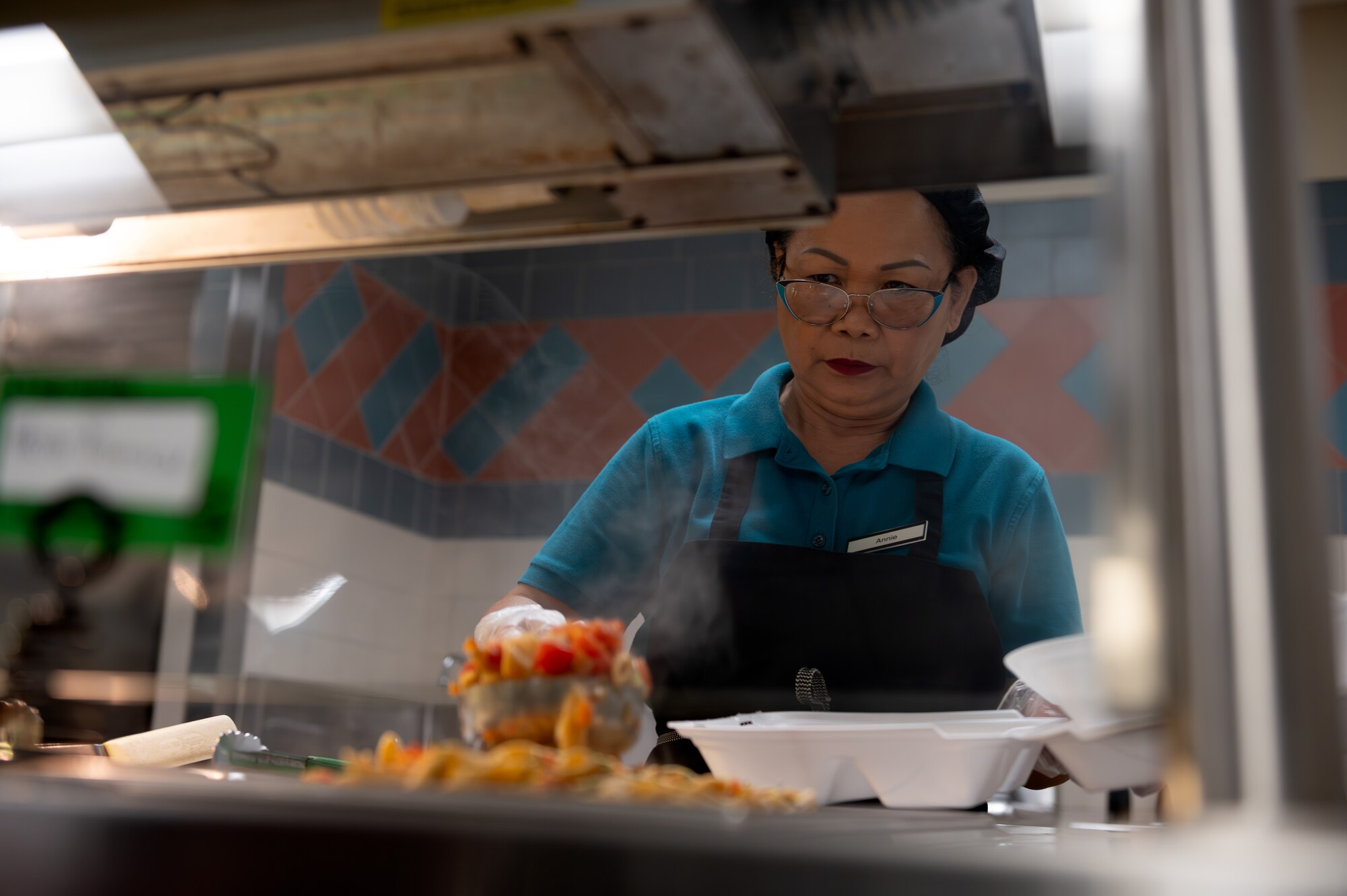 Annie Bieber, food service specialist contractor, serves a meal at the Riptide Dining Facility on Hurlburt Field, Florida, Oct. 1, 2024.