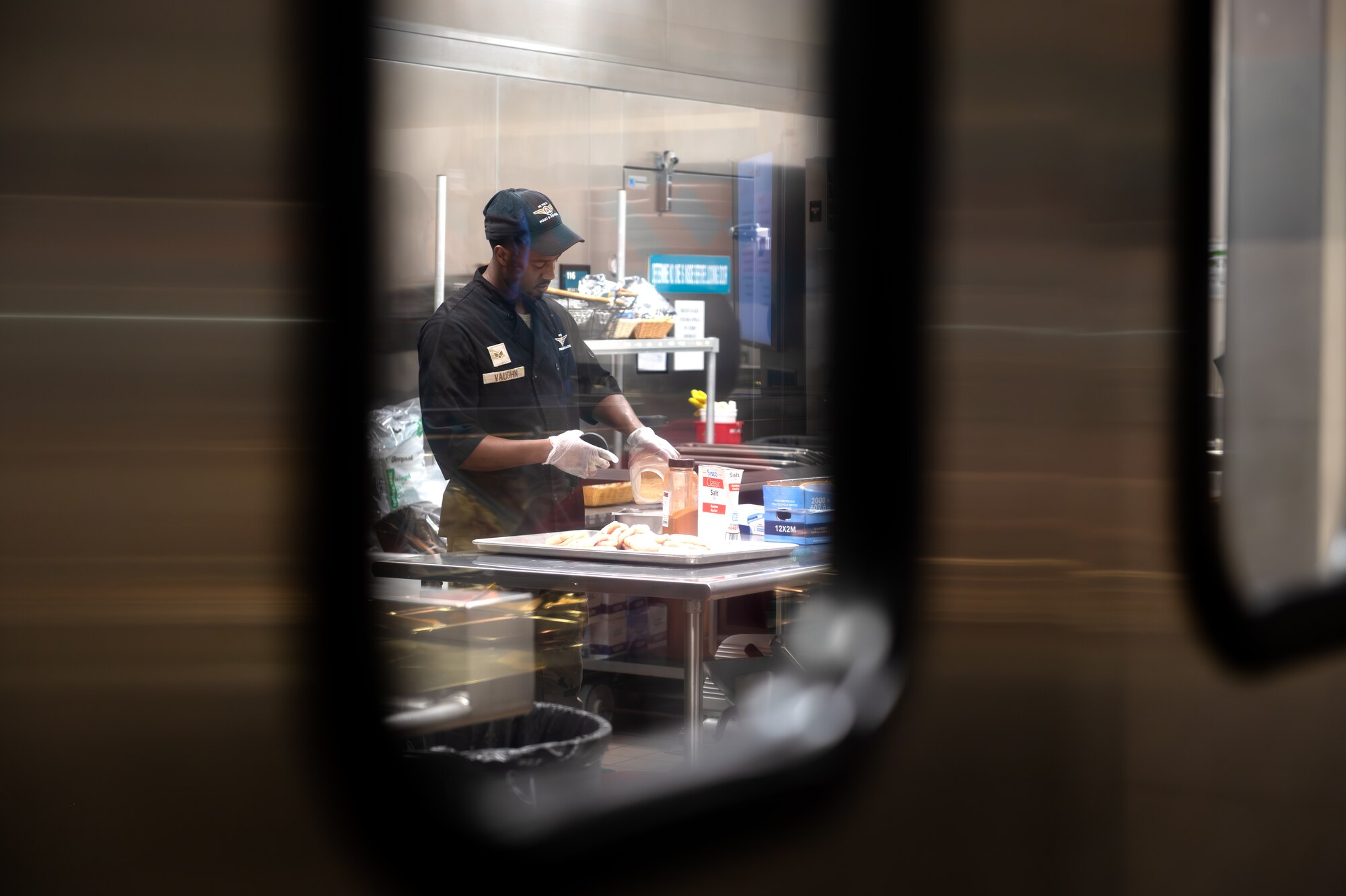 U.S. Air Force Senior Airman Richard Vaughn III, 1st Special Operations Force Support Squadron food service shift leader, seasons chicken in the Riptide Dining Facility kitchen at Hurlburt Field, Florida, Oct. 1, 2024.