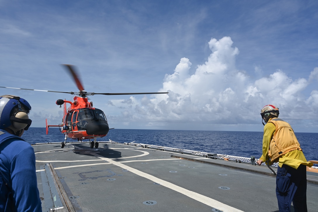 Ensign Andrew Ferderer, a crew member assigned to Coast Guard Cutter Mohawk (WMEC 913), directs the landing of a helicopter aboard the cutter’s flight deck during training, Sept. 30, 2024, while underway in the Florida Straits. Mohawk’s crew conducted a 57-day deployment to carryout maritime safety and security missions in the Seventh Coast Guard District’s area of responsibility. (U.S. Coast Guard photo by Ensign Brian Morel)