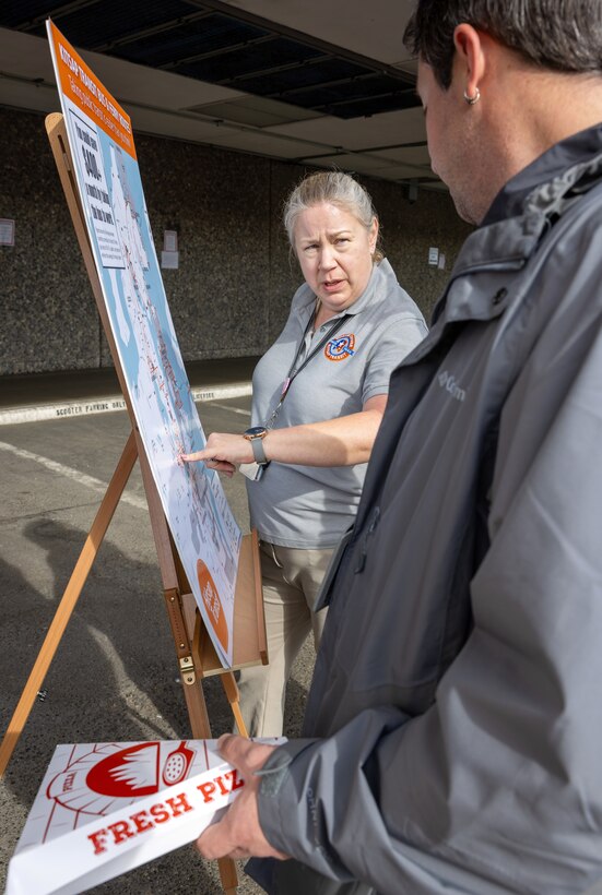 Cyndi Griffey, Worker/Driver manager, Kitsap Transit, helps a Puget Sound Naval Shipyard & Intermediate Maintenance Facility employee find a bus route on a map Oct. 9, 2024, during the PSNS & IMF Commuter Fair, in Bremerton, Washington. Carpools, vanpools and the Worker/Driver program were all highlighted during the commuter event as ways to make getting to work easier for command employees. (U.S. Navy photo by Wendy Hallmark)