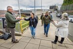 Command safety advocates hand out safety gear to employees as they exit State Street Gate Oct. 17, 2024, during the annual fall and winter “Can You See Me Now” safety campaign at Puget Sound Naval Shipyard & Intermediate Maintenance Facility in Bremerton, Washington. (U.S. Navy photo by Wendy Hallmark)