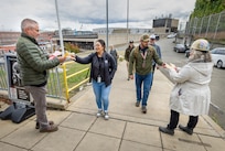 Command safety advocates hand out safety gear to employees as they exit State Street Gate Oct. 17, 2024, during the annual fall and winter “Can You See Me Now” safety campaign at Puget Sound Naval Shipyard & Intermediate Maintenance Facility in Bremerton, Washington. (U.S. Navy photo by Wendy Hallmark)