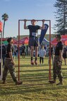 U.S. Marines from the Western Recruiting Region hold the pull-up bar for a participant during the 2024 Marine Corps Recruit Depot San Diego Boot Camp Challenge at MCRD San Diego, California, Oct. 19, 2024. For the past 23 years, MCRD San Diego has hosted the MCRD San Diego Boot Camp Challenge, a three-mile obstacle course race guided by 60 drill instructors that highlights the physical and mental demands of boot camp. The event fosters comradery and community engagement through interaction with MCRD personnel. (U.S. Marine Corps photo by Cpl. Alexandra M. Earl)