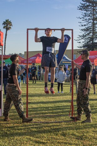 U.S. Marines from the Western Recruiting Region hold the pull-up bar for a participant during the 2024 Marine Corps Recruit Depot San Diego Boot Camp Challenge at MCRD San Diego, California, Oct. 19, 2024. For the past 23 years, MCRD San Diego has hosted the MCRD San Diego Boot Camp Challenge, a three-mile obstacle course race guided by 60 drill instructors that highlights the physical and mental demands of boot camp. The event fosters comradery and community engagement through interaction with MCRD personnel. (U.S. Marine Corps photo by Cpl. Alexandra M. Earl)