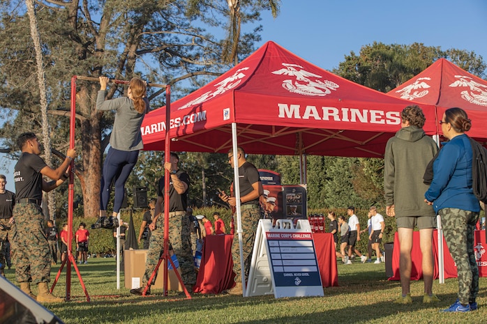 U.S. Marines from the Western Recruiting Region hold the pull-up bar for a participant during the 2024 Marine Corps Recruit Depot San Diego Boot Camp Challenge at MCRD San Diego, California, Oct. 19, 2024. For the past 23 years, MCRD San Diego has hosted the MCRD San Diego Boot Camp Challenge, a three-mile obstacle course race guided by 60 drill instructors that highlights the physical and mental demands of boot camp. The event fosters comradery and community engagement through interaction with MCRD personnel. (U.S. Marine Corps photo by Cpl. Alexandra M. Earl)