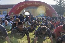 Participants of the 2024 Marine Corps Recruit Depot San Diego Boot Camp Challenge conduct push-ups as a warm-up exercise at  at MCRD San Diego, California, Oct. 19, 2024. For the past 23 years, MCRD San Diego has hosted the MCRD San Diego Boot Camp Challenge, a three-mile obstacle course race guided by 60 drill instructors that highlights the physical and mental demands of boot camp. The event fosters comradery and community engagement through interaction with MCRD personnel. (U.S. Marine Corps photo by Cpl. Alexandra M. Earl)