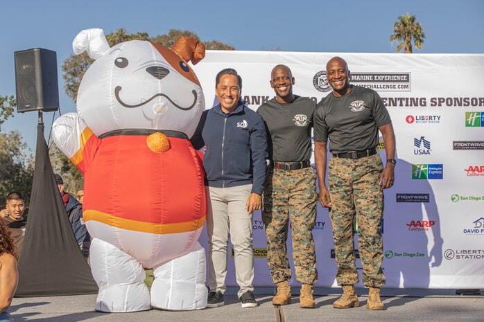 U.S. Marine Corps Brig. Gen. James A. Ryans II, commanding general, Marine Corps Recruit Depot San Diego and Western Recruiting Region, far right, and Sgt. Maj. Oranjel Leavy, sergeant major, MCRD San Diego and the WRR, center right, poses with Todd Gloria, the mayor of San Diego at MCRD San Diego, California, Oct. 19, 2024. For the past 23 years, MCRD San Diego has hosted the 2024 MCRD San Diego Boot Camp Challenge, a three-mile obstacle course race guided by 60 drill instructors that highlights the physical and mental demands of boot camp. The event fosters comradery and community engagement through interaction with MCRD personnel. (U.S. Marine Corps photo by Cpl. Alexandra M. Earl)