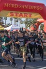 Participants of the 2024 Marine Corps Recruit Depot San Diego Boot Camp Challenge cross the starting line at  at MCRD San Diego, California, Oct. 19, 2024. For the past 23 years, MCRD San Diego has hosted the MCRD San Diego Boot Camp Challenge, a three-mile obstacle course race guided by 60 drill instructors that highlights the physical and mental demands of boot camp. The event fosters comradery and community engagement through interaction with MCRD personnel. (U.S. Marine Corps photo by Cpl. Alexandra M. Earl)