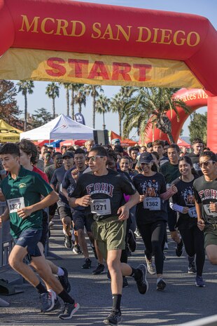Participants of the 2024 Marine Corps Recruit Depot San Diego Boot Camp Challenge cross the starting line at  at MCRD San Diego, California, Oct. 19, 2024. For the past 23 years, MCRD San Diego has hosted the MCRD San Diego Boot Camp Challenge, a three-mile obstacle course race guided by 60 drill instructors that highlights the physical and mental demands of boot camp. The event fosters comradery and community engagement through interaction with MCRD personnel. (U.S. Marine Corps photo by Cpl. Alexandra M. Earl)