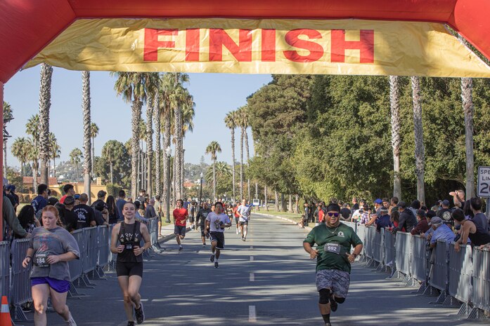 Participants of the 2024 Marine Corps Recruit Depot San Diego Boot Camp Challenge cross the finish line at  at MCRD San Diego, California, Oct. 19, 2024. For the past 23 years, MCRD San Diego has hosted the MCRD San Diego Boot Camp Challenge, a three-mile obstacle course race guided by 60 drill instructors that highlights the physical and mental demands of boot camp. The event fosters comradery and community engagement through interaction with MCRD personnel. (U.S. Marine Corps photo by Cpl. Alexandra M. Earl)