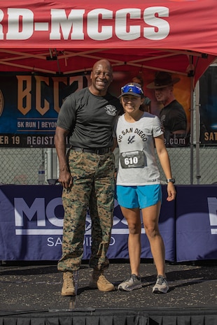 U.S. Marine Corps Brig. Gen. James A. Ryans II, commanding general, Marine Corps Recruit Depot San Diego and Western Recruiting Region, poses with Madeline McFarland, the 2nd place female participant of the 2024 MCRD San Diego Boot Camp Challenge at MCRD San Diego, California, Oct. 19, 2024. For the past 23 years, MCRD San Diego has hosted the MCRD San Diego Boot Camp Challenge, a three-mile obstacle course race guided by 60 drill instructors that highlights the physical and mental demands of boot camp. The event fosters comradery and community engagement through interaction with MCRD personnel. (U.S. Marine Corps photo by Cpl. Alexandra M. Earl)