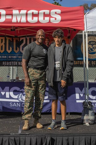 U.S. Marine Corps Brig. Gen. James A. Ryans II, commanding general, Marine Corps Recruit Depot San Diego and Western Recruiting Region, poses with Ethan Heredia, the 1st place male participant of the 2024 MCRD San Diego Boot Camp Challenge at MCRD San Diego, California, Oct. 19, 2024. For the past 23 years, MCRD San Diego has hosted the MCRD San Diego Boot Camp Challenge, a three-mile obstacle course race guided by 60 drill instructors that highlights the physical and mental demands of boot camp. The event fosters comradery and community engagement through interaction with MCRD personnel. (U.S. Marine Corps photo by Cpl. Alexandra M. Earl)
