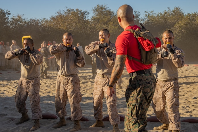 U.S. Marine Corps Staff Sgt. Ivan C. Leonmuñoz, a drill instructor with Alpha Company, 1st Recruit Training Battalion, calls out techniques during a body sparring event at Marine Corps Recruit Depot San Diego, California, Oct. 21, 2024. Recruits are taught Marine Corps Martial Arts Program techniques, which instill basic self-defense that they will execute throughout recruit training during events like body sparring and pugil sticks to help build a warrior ethos and esprit de corps. (U.S. Marine Corps photo by Lance Cpl. Janell B. Alvarez)