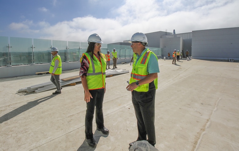 Sherene Dorazio, deputy executive director of the Department of Veterans Affairs’ Office of Construction and Facilities Management, center-left, talks with Michael Parrish, chief acquisition officer and principal executive director for DVA’s Office of Acquisition, Logistics and Construction, during a senior-leader tour Oct. 9 of the Spinal Cord Injury/Community Living Center at the Jennifer Moreno DVA Medical Center campus in San Diego.