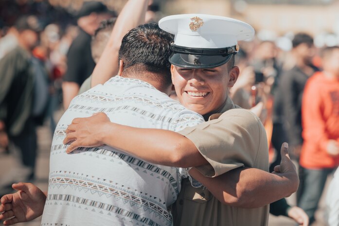 A new U.S. Marine from Bravo Company, 1st Recruit Training Battalion, is greeted by a guest after a graduation ceremony at Marine Corps Recruit Depot San Diego, California, Oct. 11, 2024. Graduation took place at the completion of the 13-week transformation, which included training for drill, marksmanship, basic combat skills, and Marine Corps customs and traditions. (U.S. Marine Corps photo by Cpl. Alexander O. Devereux)