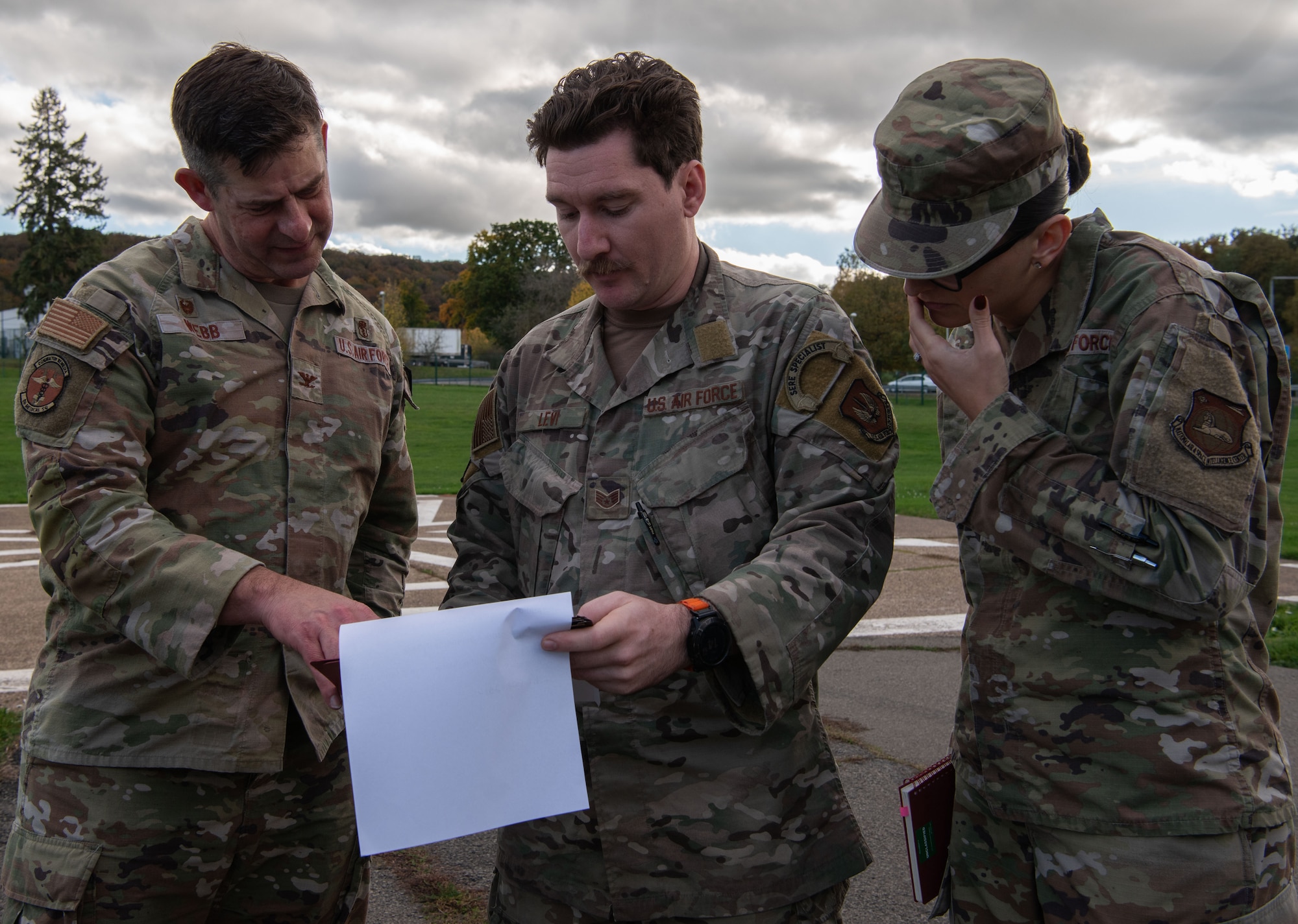 U.S. Air Force Col. Jason Webb, U.S. European Command Phase II Reintegration exercise team chief, U.S. Air Force Staff Sgt. Zachary Levi, 86th Operations Support Squadron Survival, Evasion, Resistance, and Escape debriefer, and U.S. Air Force Tech. Sgt. Taylor Decker, on-site intelligence debriefer, review Phase I documents