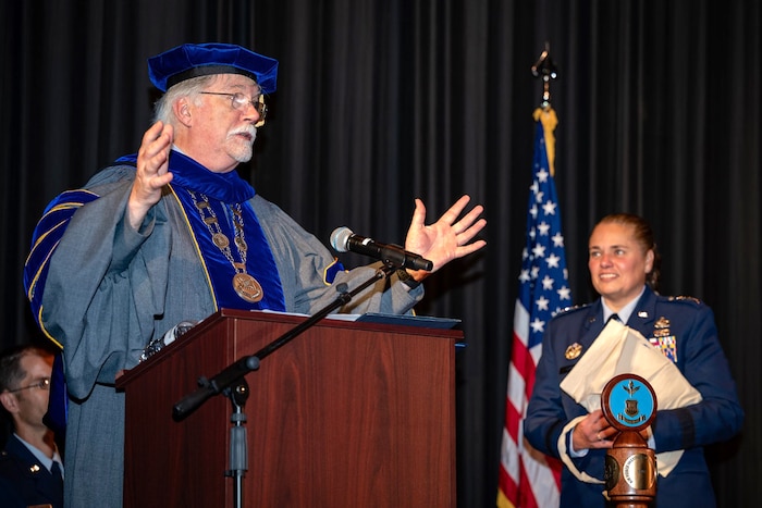 Dr. Walter Jones, Director and Chancellor, Air Force Institute of Technology, introduces commencement ceremony guest speaker Lt. Gen. Linda S. Hurry, Deputy Commander, Air Force Materiel Command, at AFIT’s commencement ceremony held Sept. 12 at the Dayton Masonic Center. (U.S. Air Force photos by Daniel Peterson)