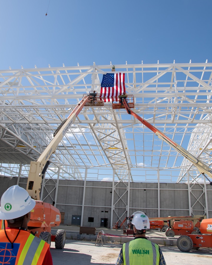 Workers secure the final beam in place at P378, a brand new CH-53K maintenance hangar under construction aboard Marine Corps Air Station New River on October 25, 2023. 

Contractor of record, Archer Western of The Walsh Group, hosted the Topping Out ceremony for OICC Florence and Marine Corps representatives to gather and sign the final roof beam before it was lifted into place at the top of the new structure.