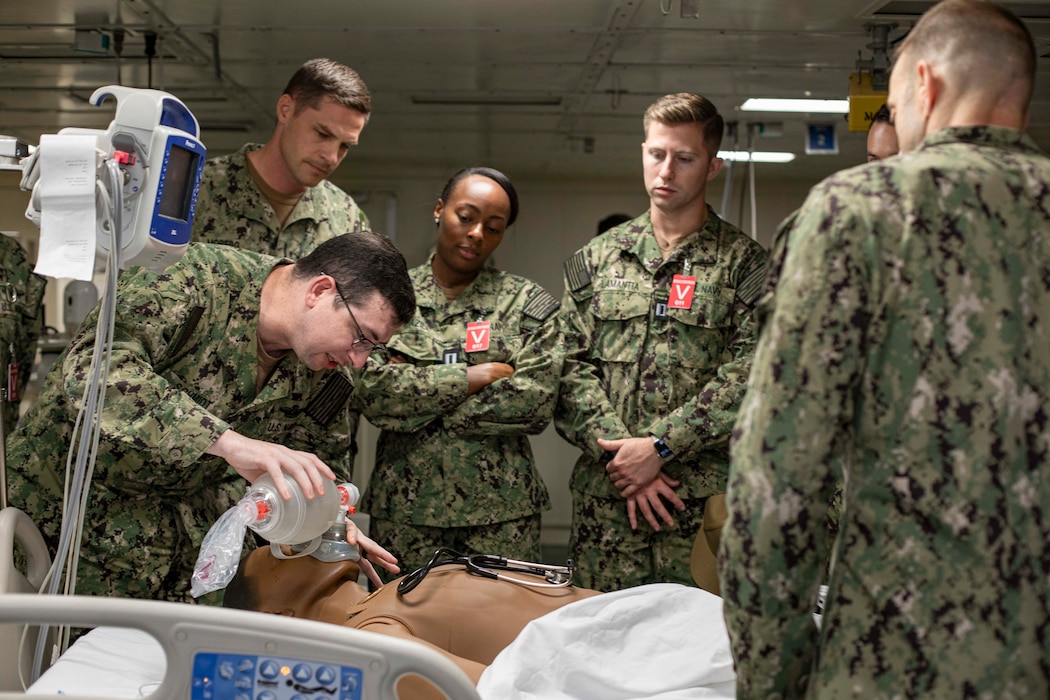 241017-N-KC192-1046 NORFOLK, Va. (Oct. 17, 2024) Lt. Rene Schmidt, a general dentist assigned to the Nimitz-class aircraft carrier USS George H.W. Bush (CVN 77), uses an assisted breathing apparatuses during dental officer triage training aboard the Wasp-class amphibious assault ship USS Iwo Jima (LHD 7), Oct. 17, 2024. Over the course of three days, Army and Navy dental officers from Iwo Jima, NMRTC Portsmouth and Fort Gregg-Adams Dental Clinic Command conducted mass casualty, tactical combat casualty care, and triage training. (U.S. Navy photo by Mass Communication Specialist 2nd Class Levi Decker)