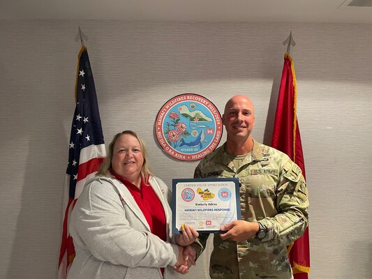 Adkins receiving her award from Lt. Col. Jones