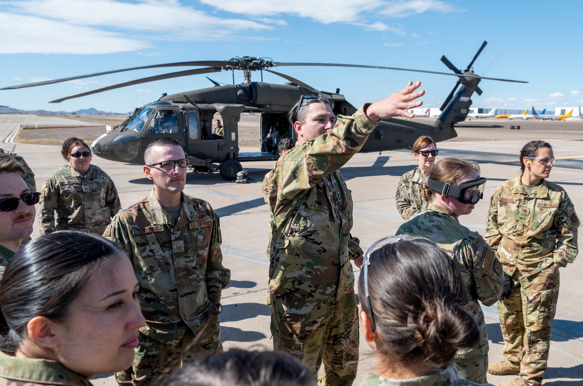 An Arizona Army National Guard Soldier gives instructions to 944th Fighter Wing Reserve Citizen Airmen during joint medevac training at Goodyear Phoenix Airport, Goodyear, Ariz., Oct. 19, 2024. The training focused on cold and hot loading of patients in preparation for the upcoming Exercise Desert Hammer 25-1 in November. (U.S. Air Force photo by Senior Airman Alexis Orozco)