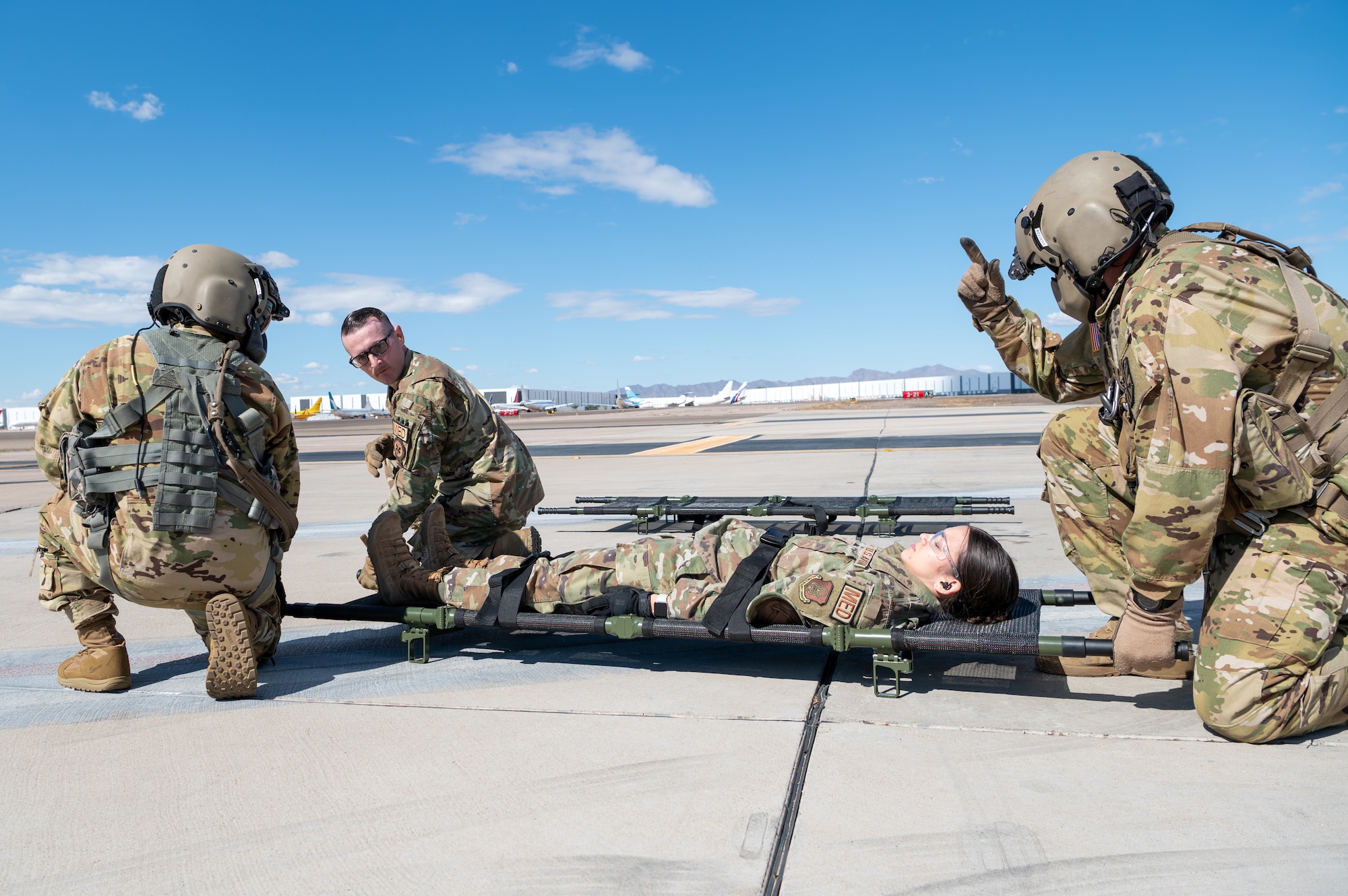 944th Fighter Wing Reserve Citizen Airmen receive instructions from Arizona Army National Guard Soldiers on proper medevac procedures during joint training at Goodyear Phoenix Airport, Goodyear, Ariz., Oct. 19, 2024. The joint medevac training prepares both units for upcoming missions, including Exercise Desert Hammer 25-1 in November. (U.S. Air Force photo by Senior Airman Alexis Orozco)