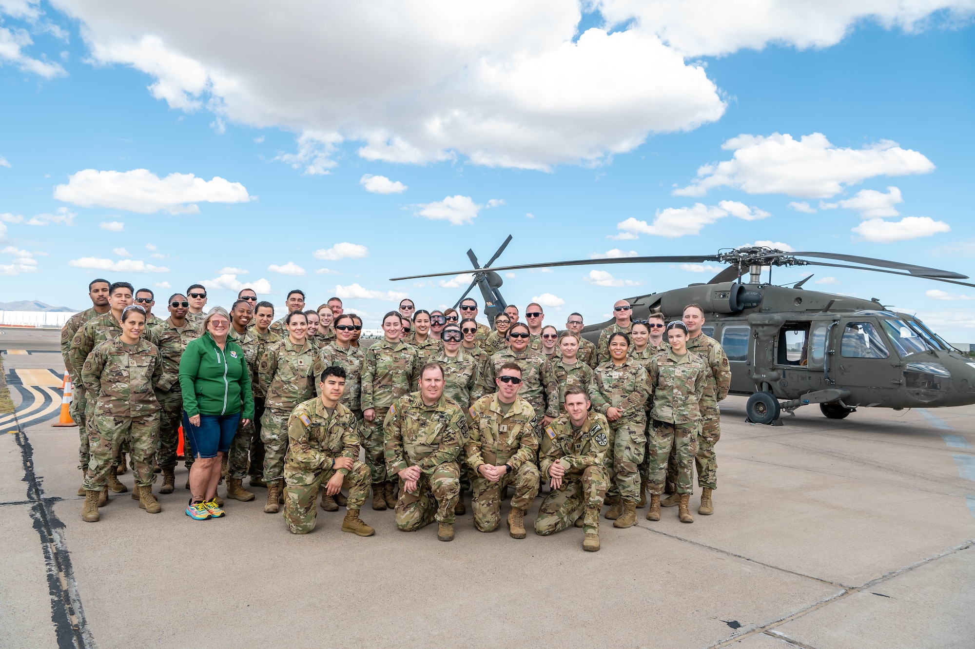 944th Fighter Wing Reserve Citizen Airmen and Arizona Army National Guard personnel pose for a group photo in front of a UH-60 Black Hawk helicopter after completing medevac training at Goodyear Phoenix Airport, Goodyear, Ariz., Oct. 19, 2024. The joint training readied the team for upcoming large-scale exercises such as Exercise Desert Hammer 25-1 in November. (U.S. Air Force photo by Senior Airman Alexis Orozco)