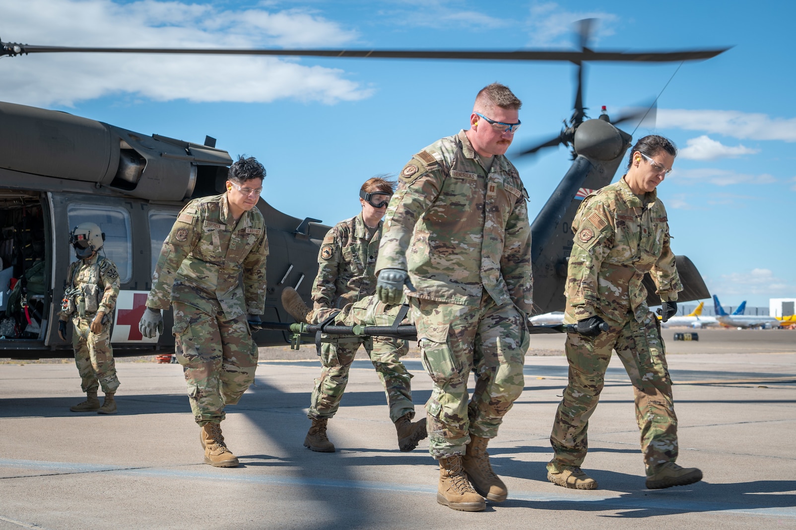 944th Fighter Wing Reserve Citizen Airmen and Arizona Army National Guard personnel work together to carry a simulated patient on a stretcher during UH-60 Black Hawk helicopter medevac training at Goodyear Phoenix Airport, Goodyear, Ariz., Oct. 19, 2024. The training emphasized joint interoperability and patient loading procedures in preparation for Exercise Desert Hammer 25-1, scheduled for November. (U.S. Air Force photo by Senior Airman Alexis Orozco)