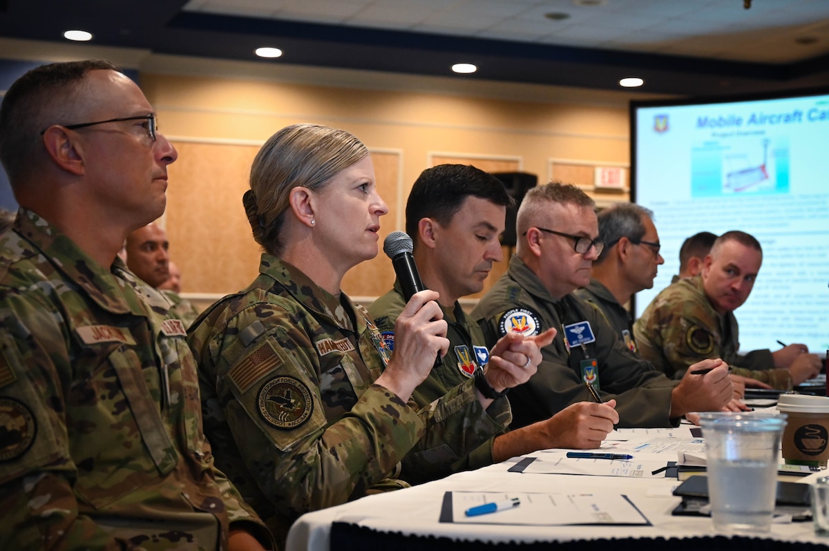 Brig. Gen. Jennifer Hammerstedt, Air Combat Command director of logistics, engineering, and force protection, engages with the presenter during Innovation Challenge at Joint Base Langley-Eustis