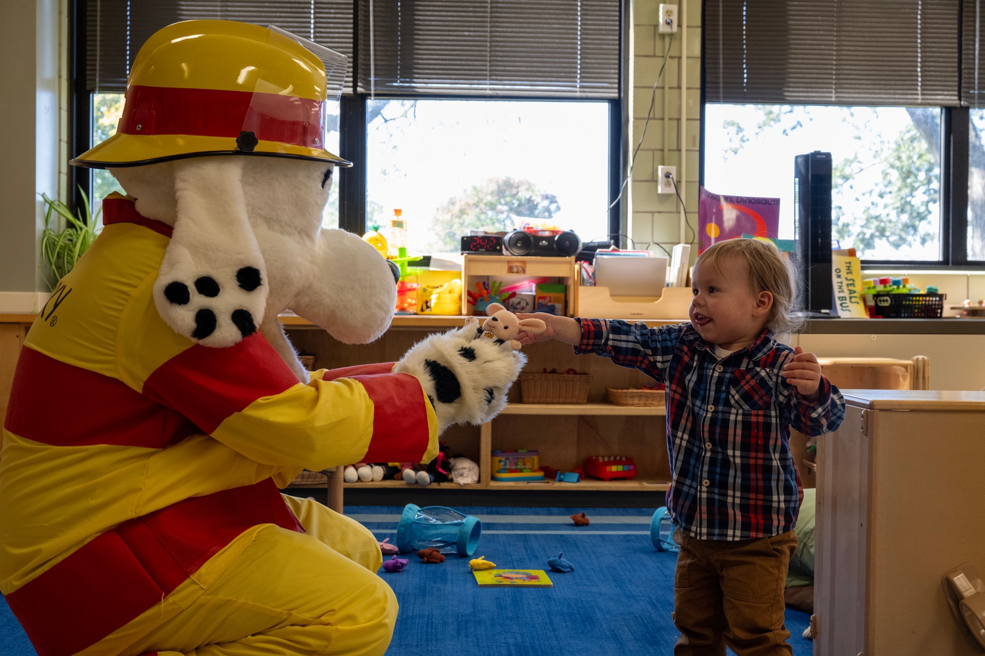 Sparky the Fire Dog visits the Wright Care Child Development Center at Wright-Patterson Air Force Base, Ohio, Oct. 8, 2024. The 2024 Fire Prevention Week theme, “Smoke alarms: Make them work for you!” encourages families to practice fire safety by regularly checking their smoke alarms. (U.S. Air Force photo by Jack Gardner)