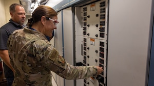 woman flipping fuse in server room