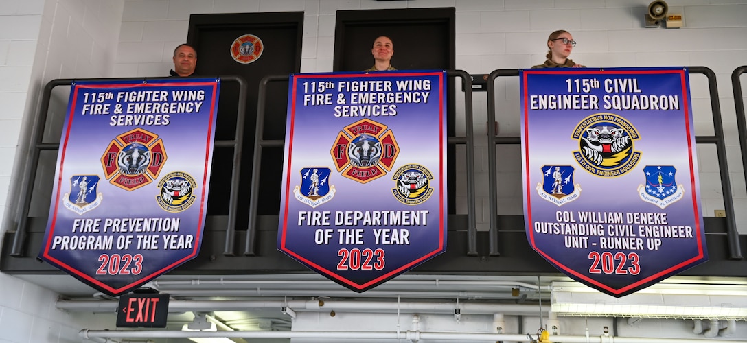 Members assigned to the 115th Fighter Wing Fire and Emergency Services reveal award banners at the Truax Field fire department in Madison, Wisconsin on March 3, 2024.