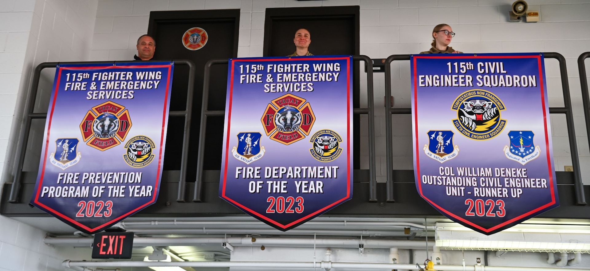 Members assigned to the 115th Fighter Wing Fire and Emergency Services reveal award banners at the Truax Field fire department in Madison, Wisconsin on March 3, 2024.